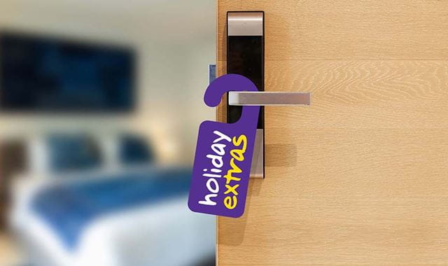 Hotel room with holiday extras on the door handle
